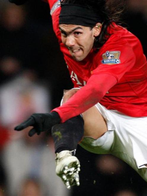 Manchester United's Carlos Tevez scores his fourth goal against Blackburn Rovers during their...