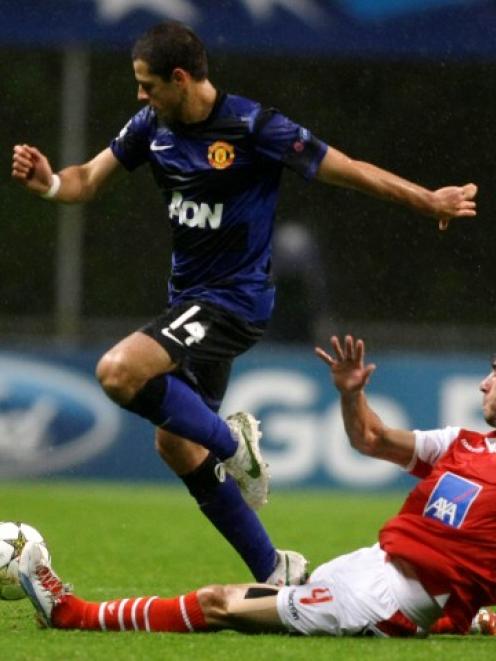 Manchester United's Javier Hernandez (L) is challenged by Braga's Nuno Andre Coelho during their...