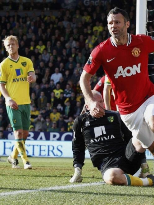 Manchester United's Ryan Giggs (R) celebrates after scoring during their Premier League match...