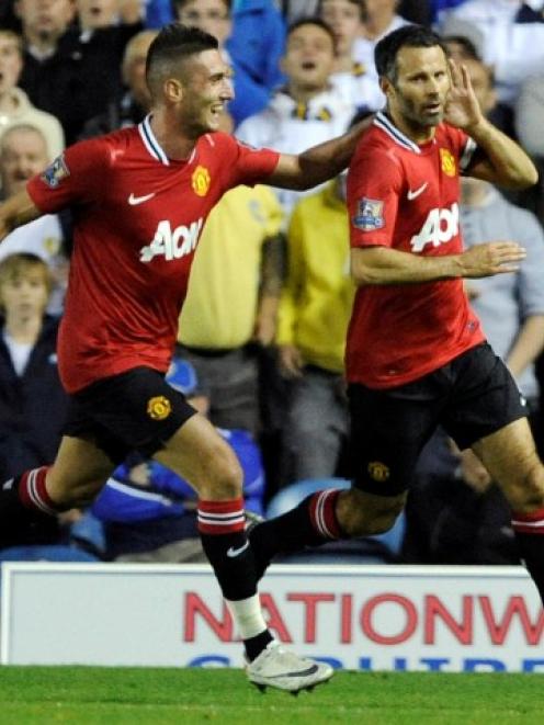 Manchester United's Ryan Giggs (R) celebrates scoring with Federico Macheda during their English...