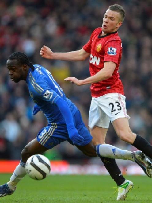 Manchester United's Tom Cleverley (R) challenges Chelsea's Victor Moses during their FA Cup...