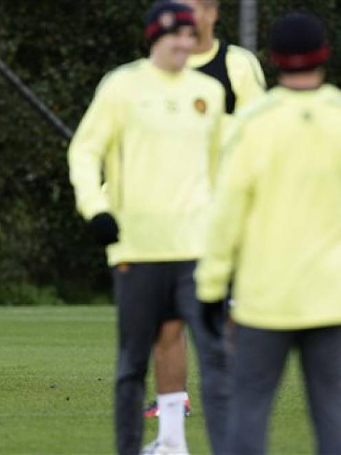 Manchester United's Wayne Rooney, left, during a training session with teammates as manager Alex...