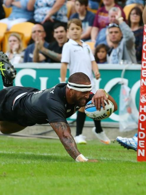 Manu Vatuvei dives over to score for New Zealand against Australia during their Anzac test in...