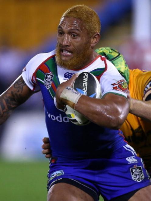 Manu Vatuvei of the Warriors beats the tackle of the Broncos' Todd Lowrie. (Photo by Simon Watts...