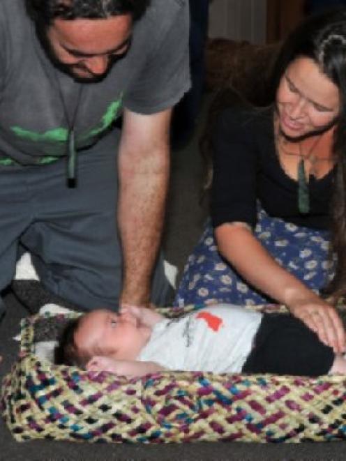 Marcus Tuwairua (33) and Hana Park (31), of Waitati, sing to their 9-week-old son Rokomai...