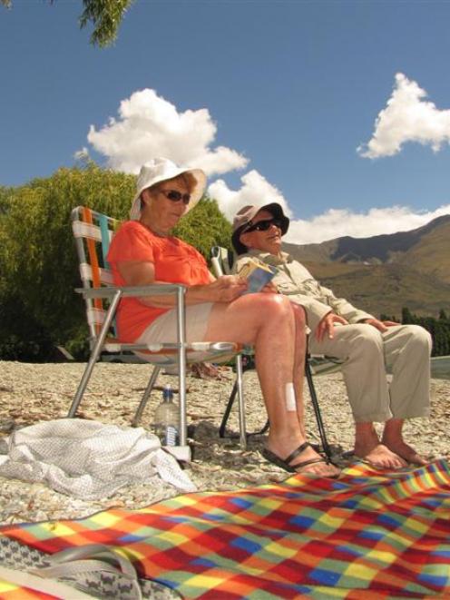 Margaret and Colin Dawson, of Dunedin, soak up the sun on the shores of Lake Wanaka yesterday....