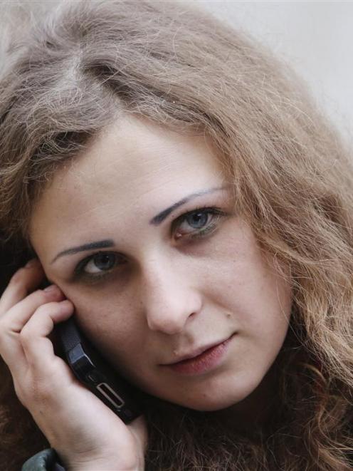 Maria Alyokhina, member of Russian punk band Pussy Riot, speaks on a telephone after her release...