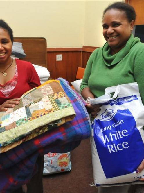 Maria Heutagi and Joy Breward, of Dunedin's Solomon Islands community, are pictured with food and...