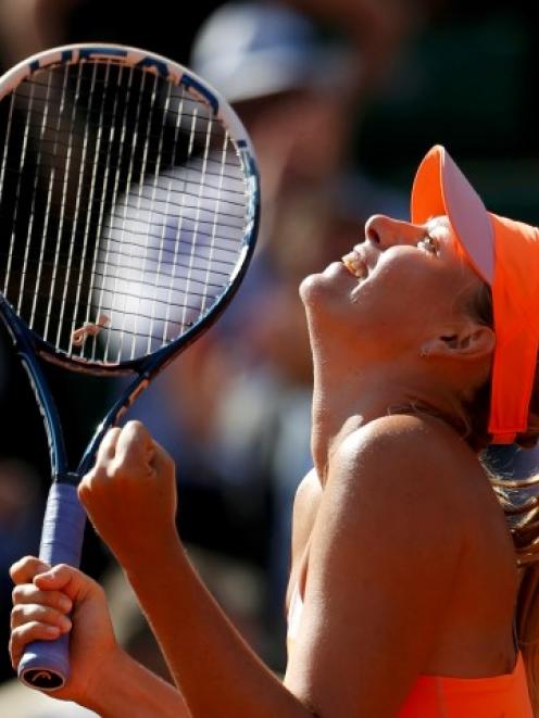 Maria Sharapova celebrates her win over Eugenie Bouchard. REUTERS/Vincent Kessler