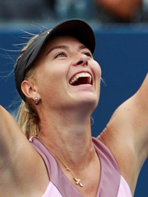 Maria Sharapova of Russia celebrates after defeating Marion Bartoli of France during their women...