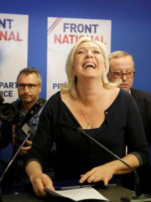 Marine Le Pen, France's National Front political party head, reacts to results after the polls...