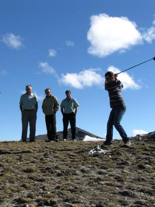 Mark Cameron tries on his best swing at the top of the Remarkables last Saturday, while the rest...