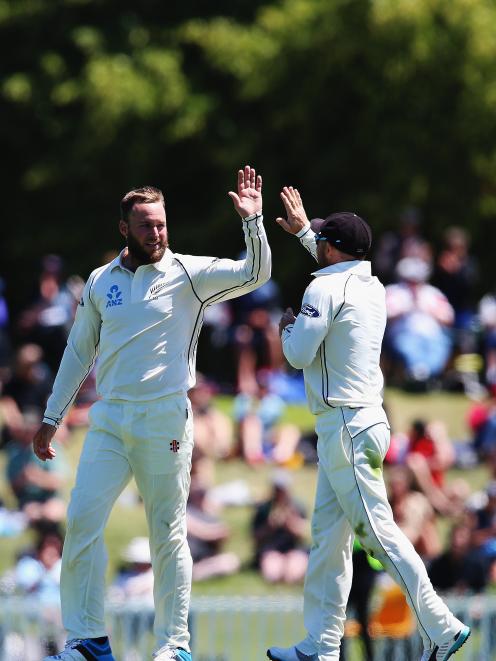 Mark Craig celebrates with Brendon McCullum after claiming the wicket of Prasanna Jayawardene of...