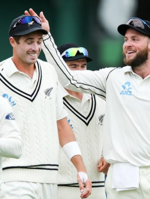 New Zealand spinner Mark Craig (R) celebrates the series win with teammate Tim Southee. Photo by...
