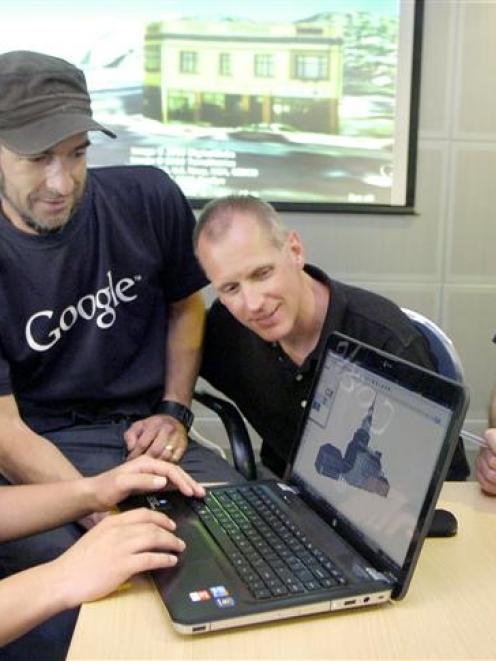 Mark McKenzie (left) learns how to render a building in 3D that could be uploaded to Google Earth...