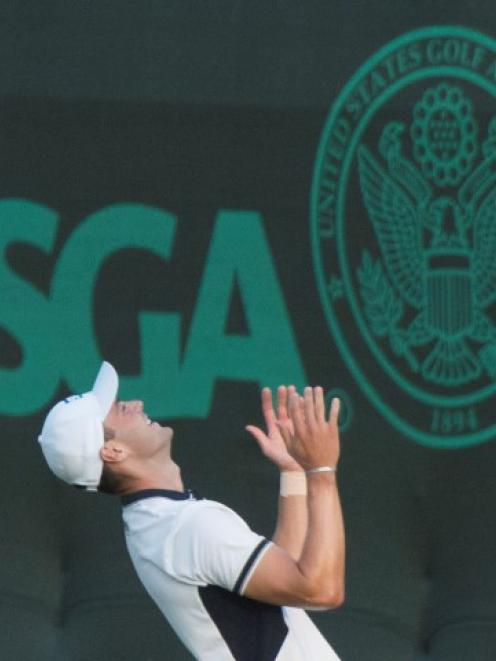 Martin Kaymer celebrates after putting out on the 18th green during the final round of the US...