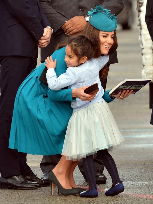 Mataawhio Matahaere-Veint (5) hugs the Duchess of Cambridge at Dunedin International Airport...