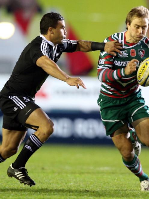 Mathew Tait of Leicester Tigers is tackled by Kade Poki.  (Photo by Ross Kinnaird/Getty Images)