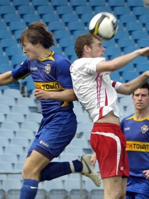Matt Boyd, of Canterbury, beats Otago United's Tristan Prattley to a high ball as United's Andy...