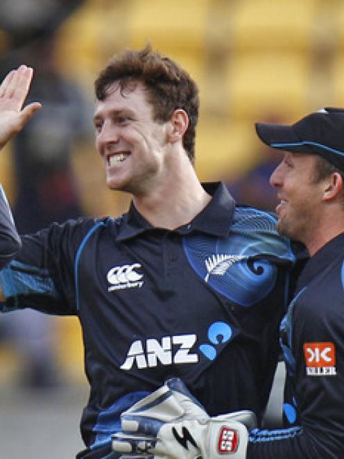 Matt Henry is congratulated by teammates after taking a wicket against India last year. Photo /...