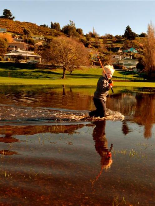Max Dunjey (2) tries his luck at fishing in flooded Orana Park in Oamaru yesterday. All he caught...