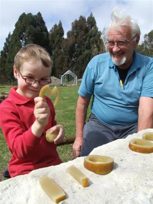 Max Itter (7) holds the letter M, carved from kelp, watched by "grandpa" mentor Allan Adamson at...