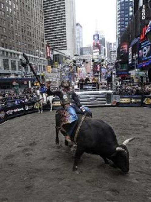 McKennon Wimberly rides Little Mr. T during the Professional Bull Riders competition in New York...