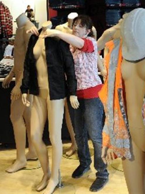 Megan Tregilgas, from Sydney, dresses mannequins for the opening of the new Levi's shop in the...