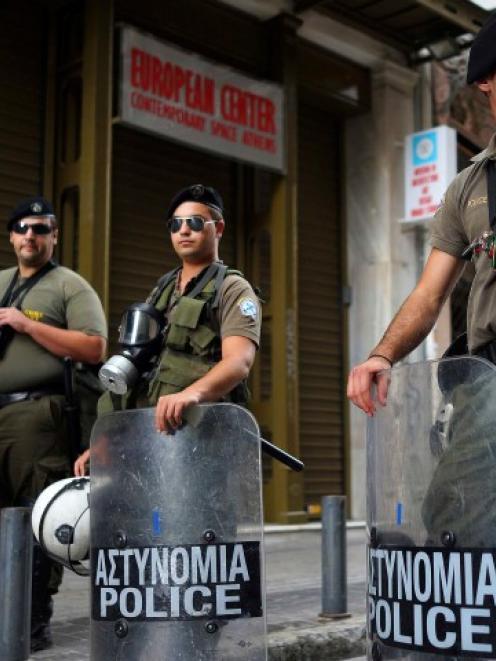 Members of a Special Police unit secure an area following the shootout in central Athens. REUTERS...