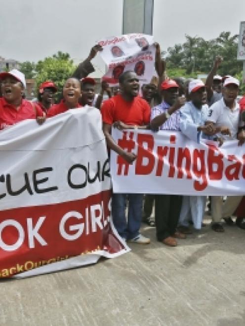 Members of the #BringBackOurGirls campaign group protest on a street, after challenging the...