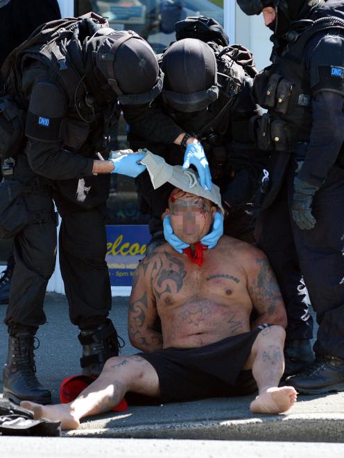 Members of the Dunedin armed offenders squad provide first aid to a  man in Princes St, Dunedin,...