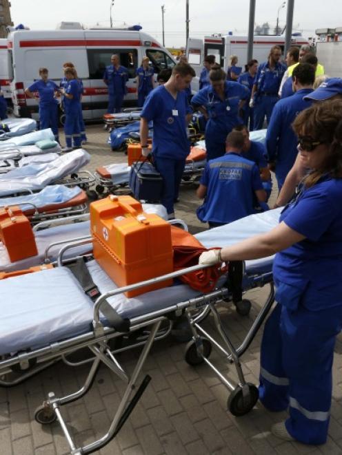 Members of the emergency services wait outside a metro station following an accident on the...