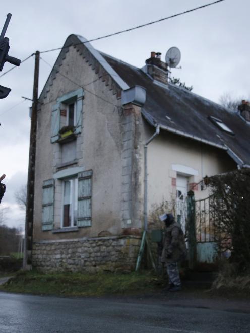 Members of the French GIPN intervention police forces secure a neighbourhood in Corcy, northeast...