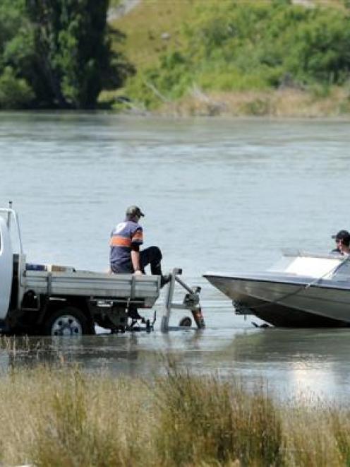 Members of the National Police Dive Squad, from Wellington, head out on the Clutha River to...