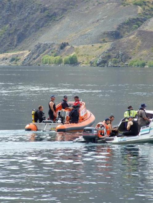 Members of the national police dive team are taken out to resume their search yesterday afternoon...