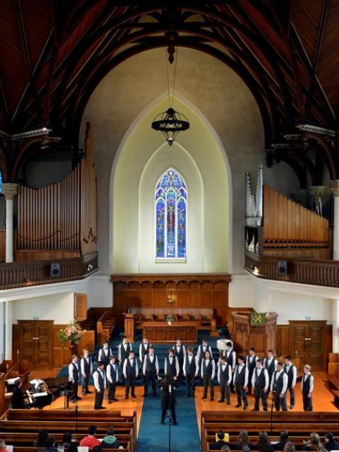 Members of the Otago Boys' High School choir Mandate perform under the musical direction of...