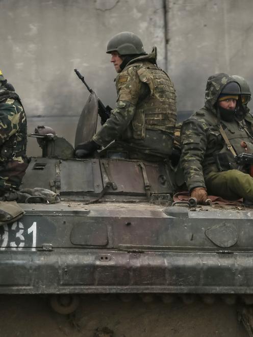 Members of the Ukrainian armed forces ride on an armoured personnel carrier near Artemivsk,...