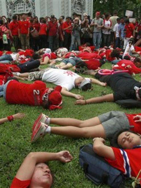 Members of the United Front for Democracy against Dictatorship (UDD) or Red Shirts stage die-in...