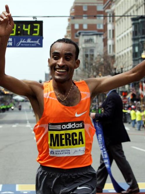 Mens winner Deriba Merga of Ethiopia reacts at the finish line in Boston at the 113th running of...