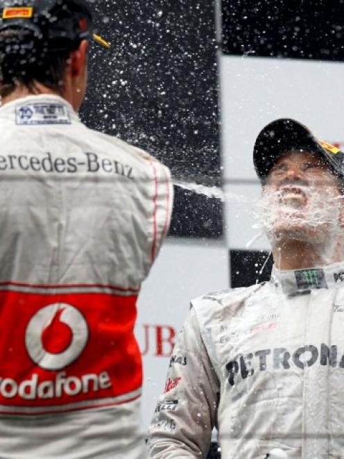 Mercedes driver Nico Rosberg of Germany is sprayed with champagne during the podium ceremony...