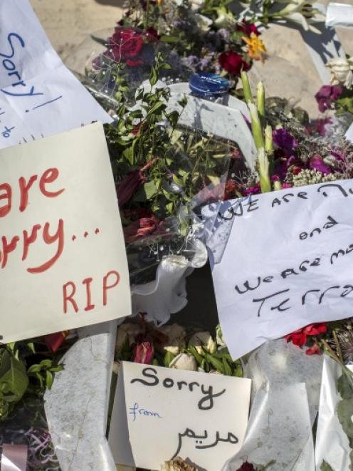 Messages and flowers are placed at the beach of the Imperial Marhaba resort, which was attacked...