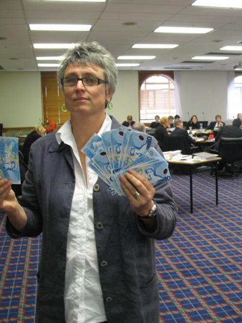 Methodist Mission chief executive Laura Black holds fake money she used as a prop during annual...