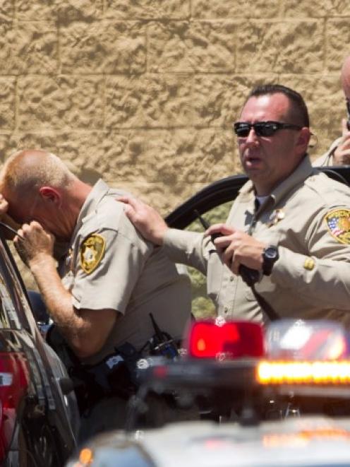 Metro Police officers at the scene outside the Wal-Mart store. REUTERS/Las Vegas Sun/Steve Marcus