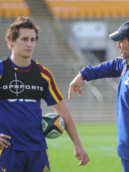 Michael Hobbs listens to some advice from Highlanders head coach Glenn Moore at Carisbrook...