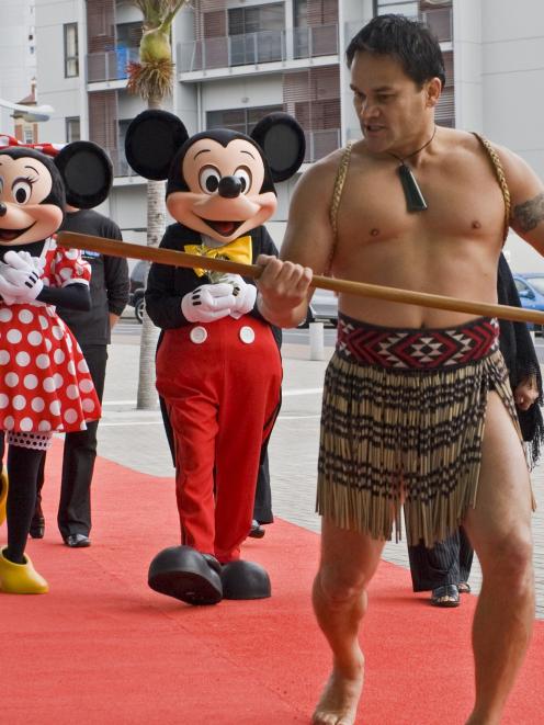 Mickey and Minnie Mouse receive a traditional welcome on Tuesday from Piripi Menary of Te Puru o...