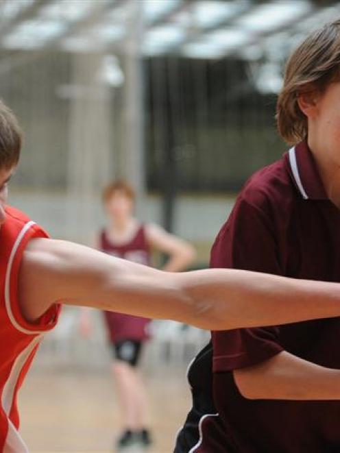 Mike Brockie (left, Kaikorai Valley College) disputes possession with Tommy-Lee Winder (Logan...