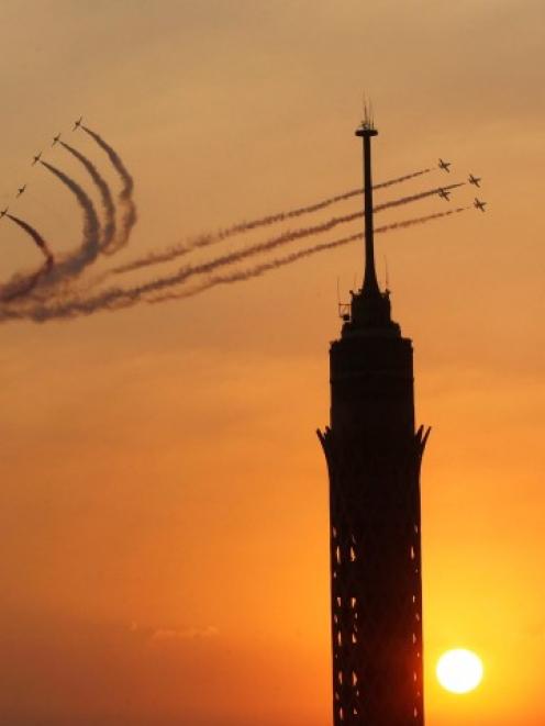 Military jets fly in formation over Cairo as the head of Egypt's constitution court Adli Mansour...