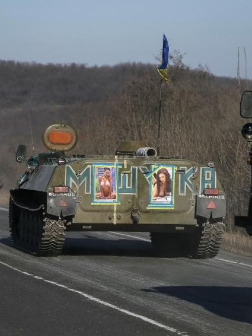 Military vehicles of the Ukrainian armed forces are seen near Artemivsk, eastern Ukraine. Photo...