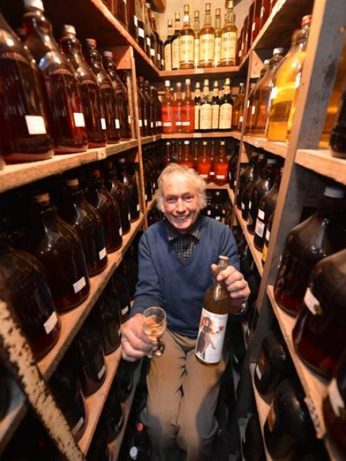 Milton wine-maker Colin Weatherall samples a 1976 crab-apple wine in a section of his cellar...