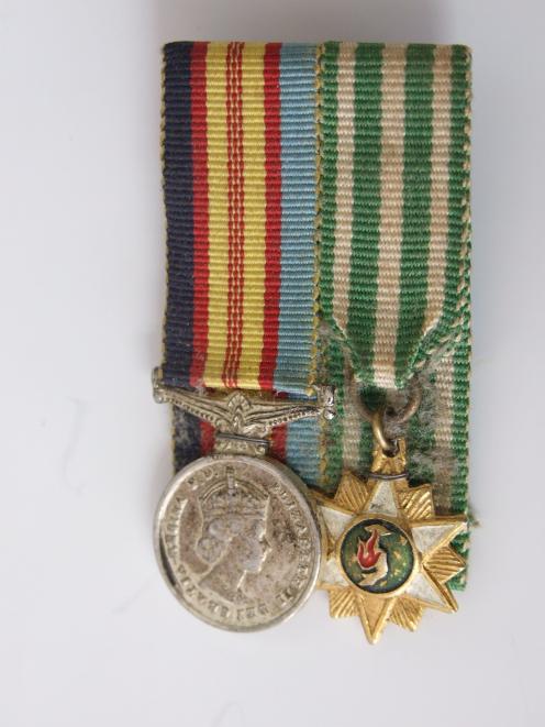 Miniatures of two of the stolen medals. On the left is the Vietnam Medal and to the right is the...